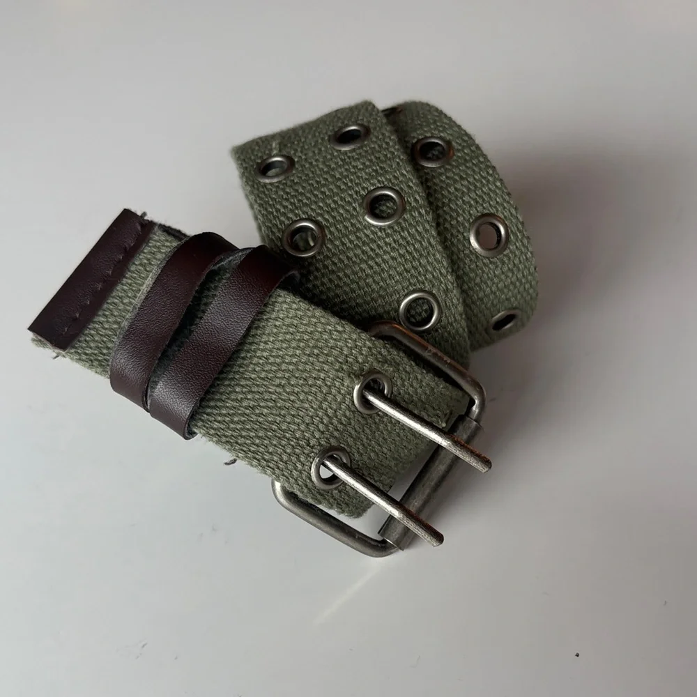 Olive Green Canvas Belt with brown accents. Silver tone hook loops.